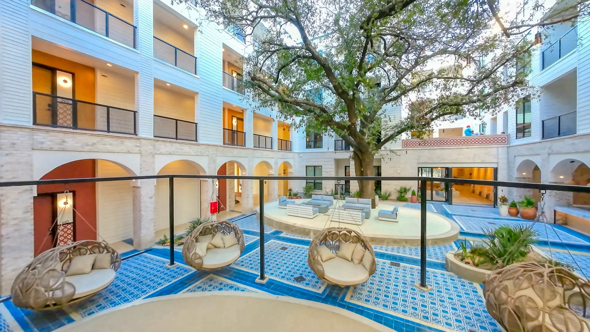 Tree-lined yard at Bishop Canopy Apartments, with towering trees providing shade and a tranquil outdoor space.